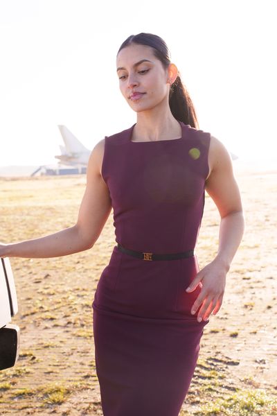 Private jet fashion shoot organised by Marsha Bagmeijer, model in a burgundy dress on the airfield at golden hour